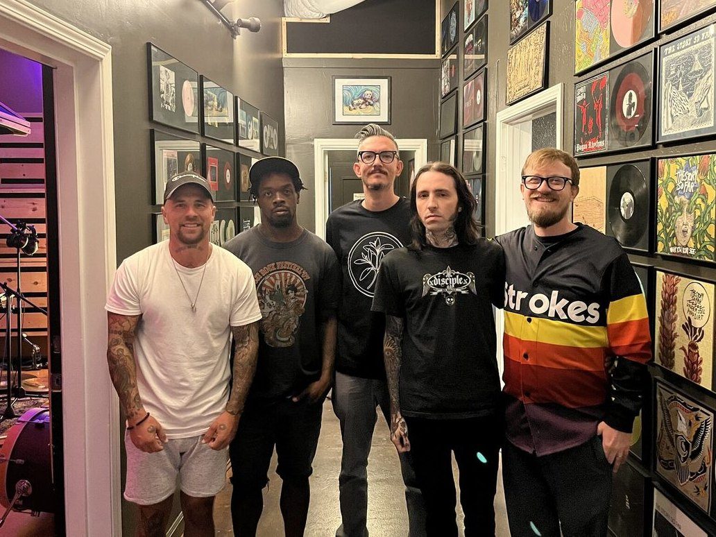 Group photo at The Panda Studios in front of the vinyl wall